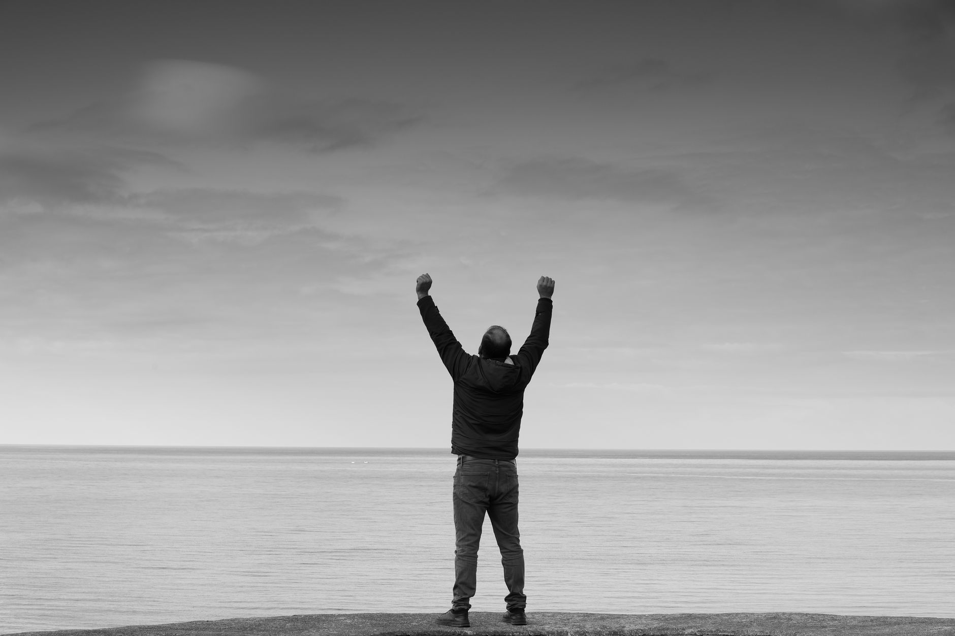 A person calmly looking out of a window, symbolising overcoming fear and gaining perspective